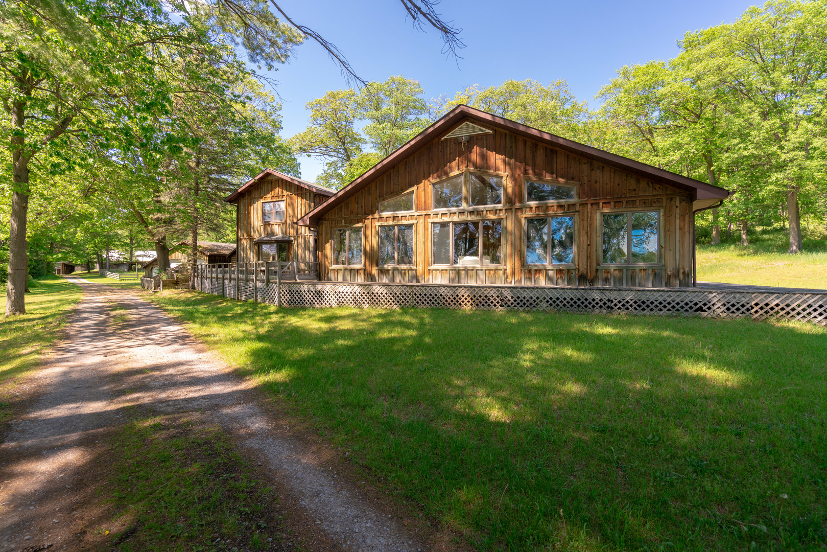 5021 Solomon Road Atlanta, MI 49709 - Photo 5 of 34 a front view of a house with yard and green space