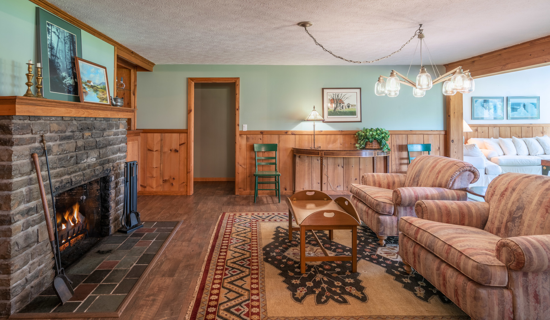 5021 Solomon Road Atlanta, MI 49709 - Photo 10 of 34 a living room with furniture and a fireplace
