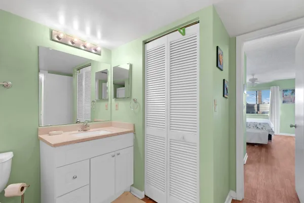 a bathroom with a sink a mirror and a shower