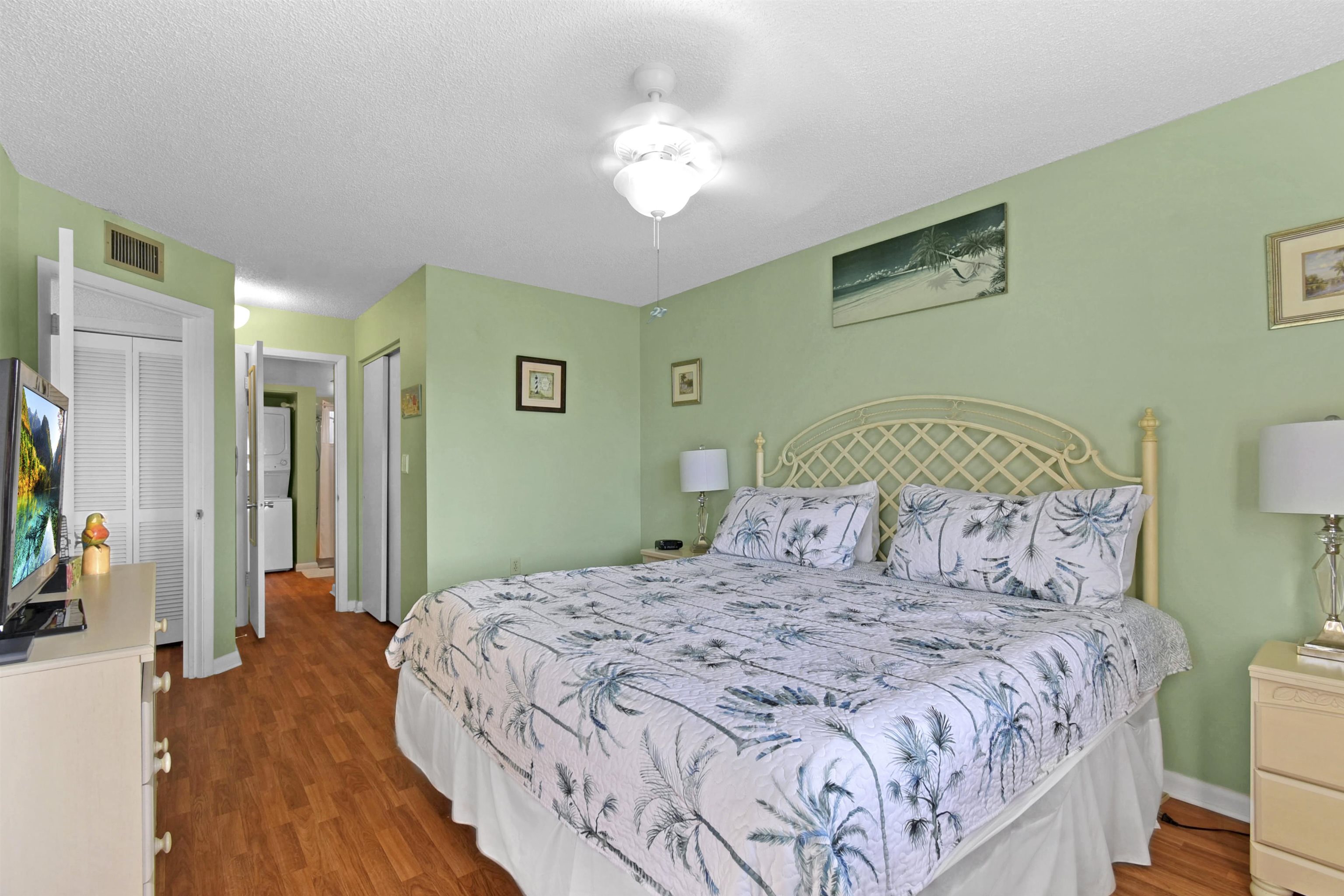 4250 A1A South, Unit C26 St. Augustine, FL 32080 - Photo 15 of 39 a bedroom with a large bed and a chandelier