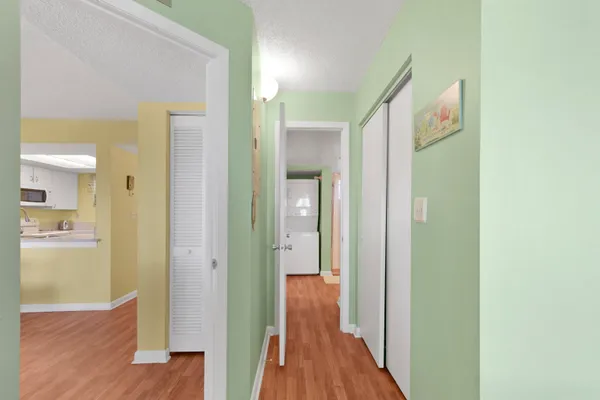 a view of a hallway with wooden floor