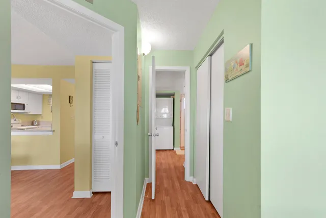 a view of a hallway with wooden floor