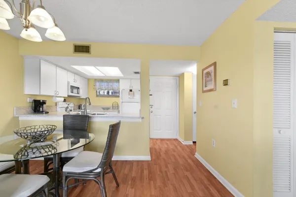 a view of a dining room with furniture and wooden floor