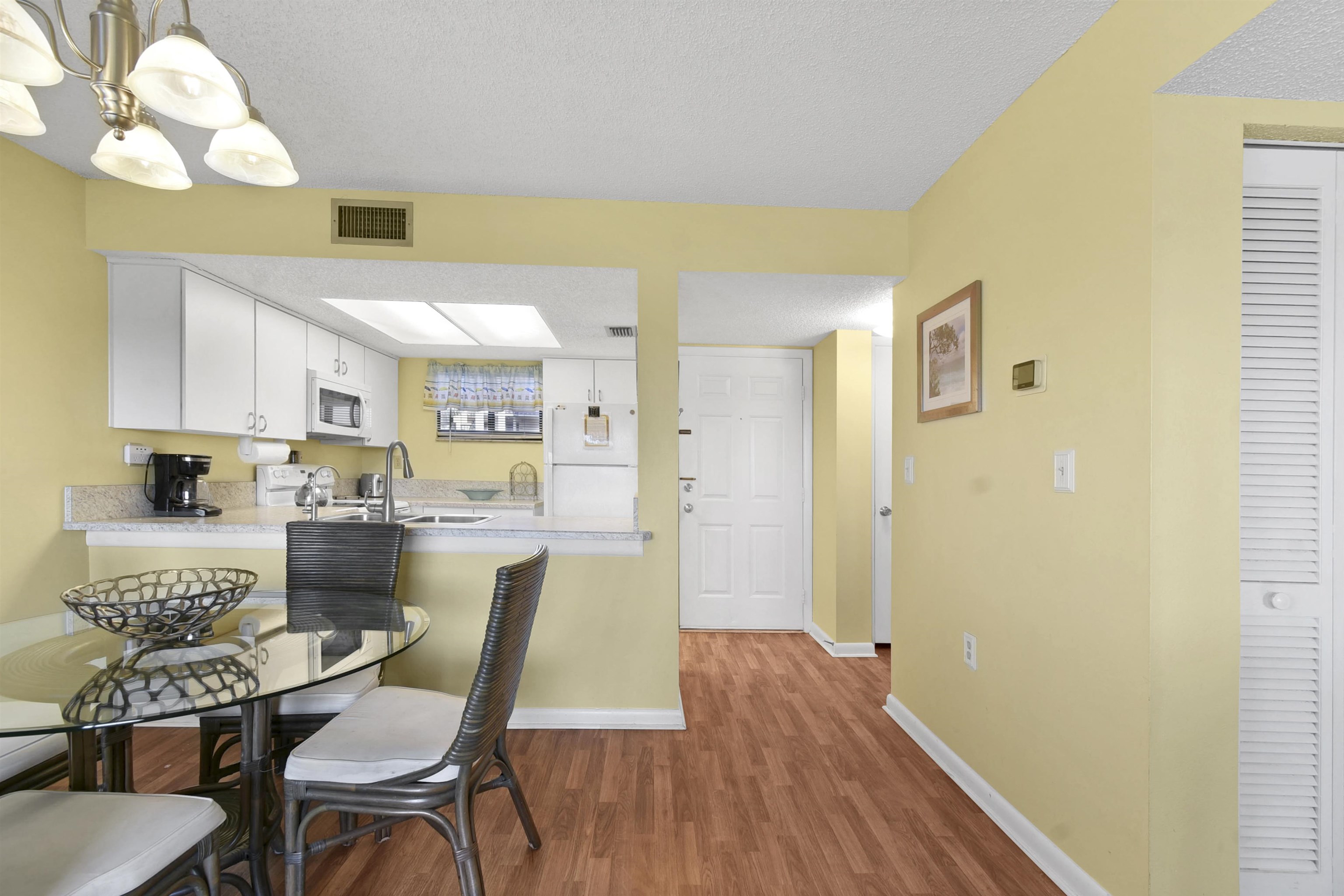 4250 A1A South, Unit C26 St. Augustine, FL 32080 - Photo 21 of 39 a view of a dining room with furniture and wooden floor