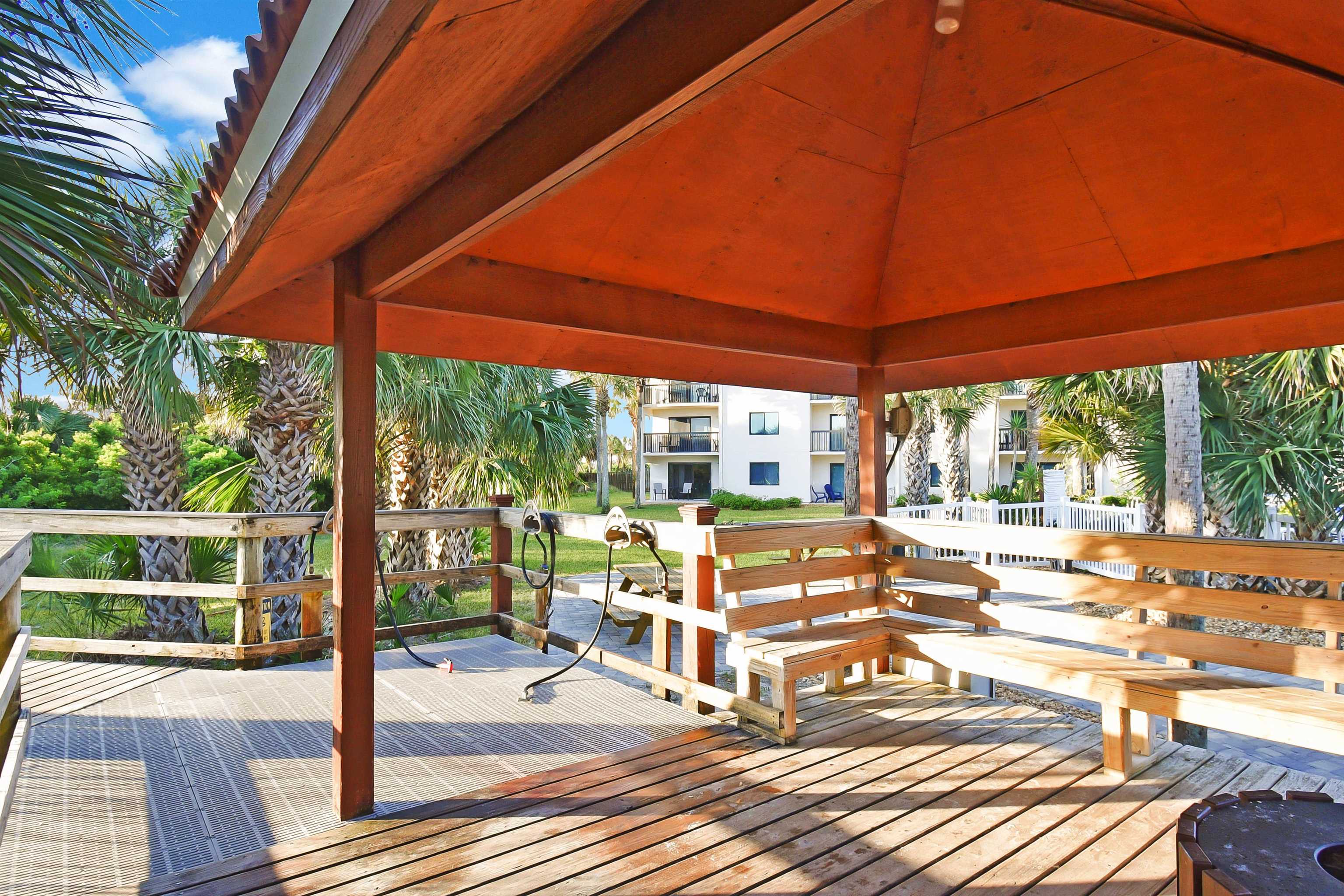 4250 A1A South, Unit C26 St. Augustine, FL 32080 - Photo 36 of 39 a view of a patio with table and chairs under an umbrella