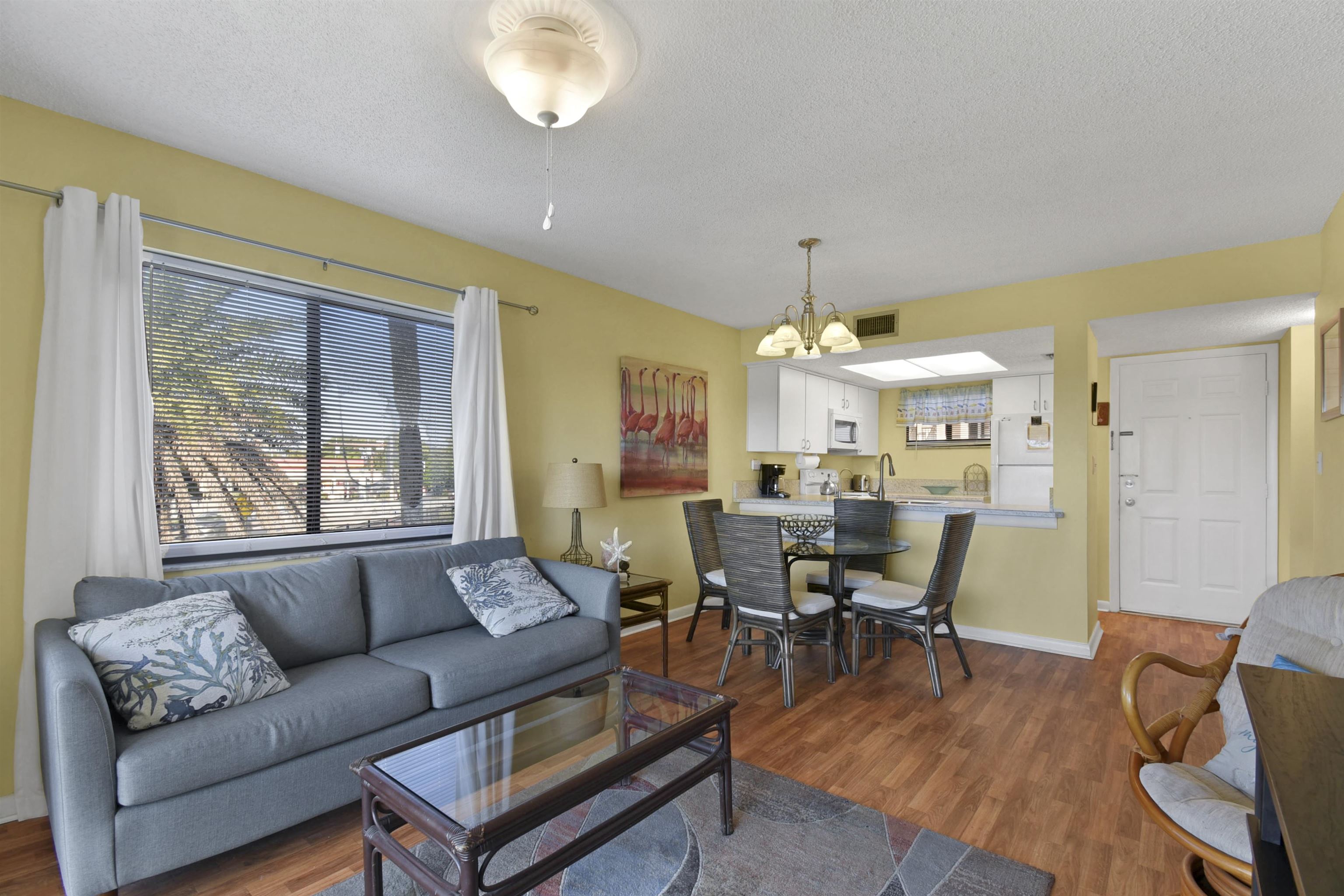 4250 A1A South, Unit C26 St. Augustine, FL 32080 - Photo 5 of 39 a living room with furniture a chandelier and a dining table