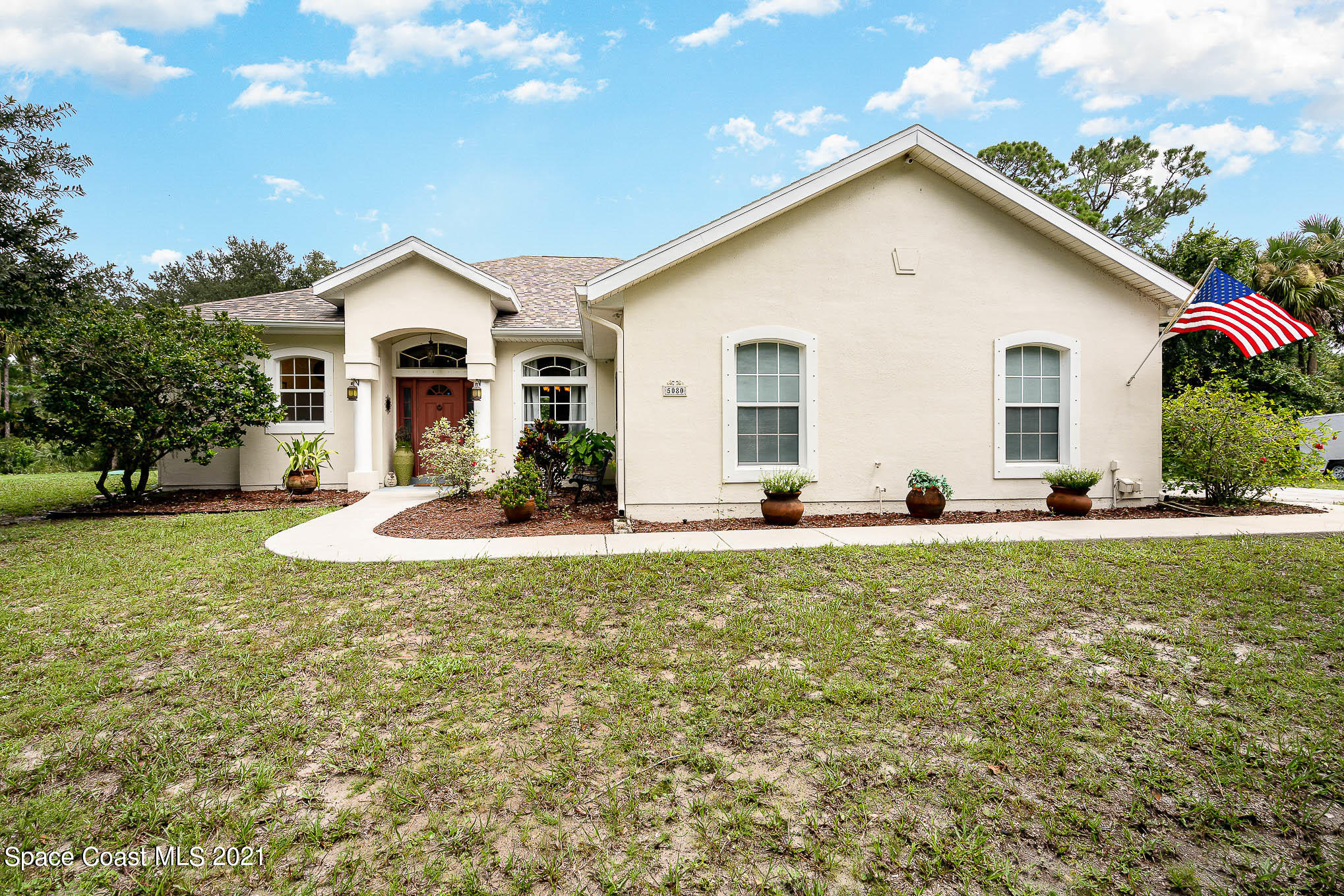 5080 Craig Road Cocoa, FL 32926 - Photo 1 of 41 a view of a house with backyard and trees