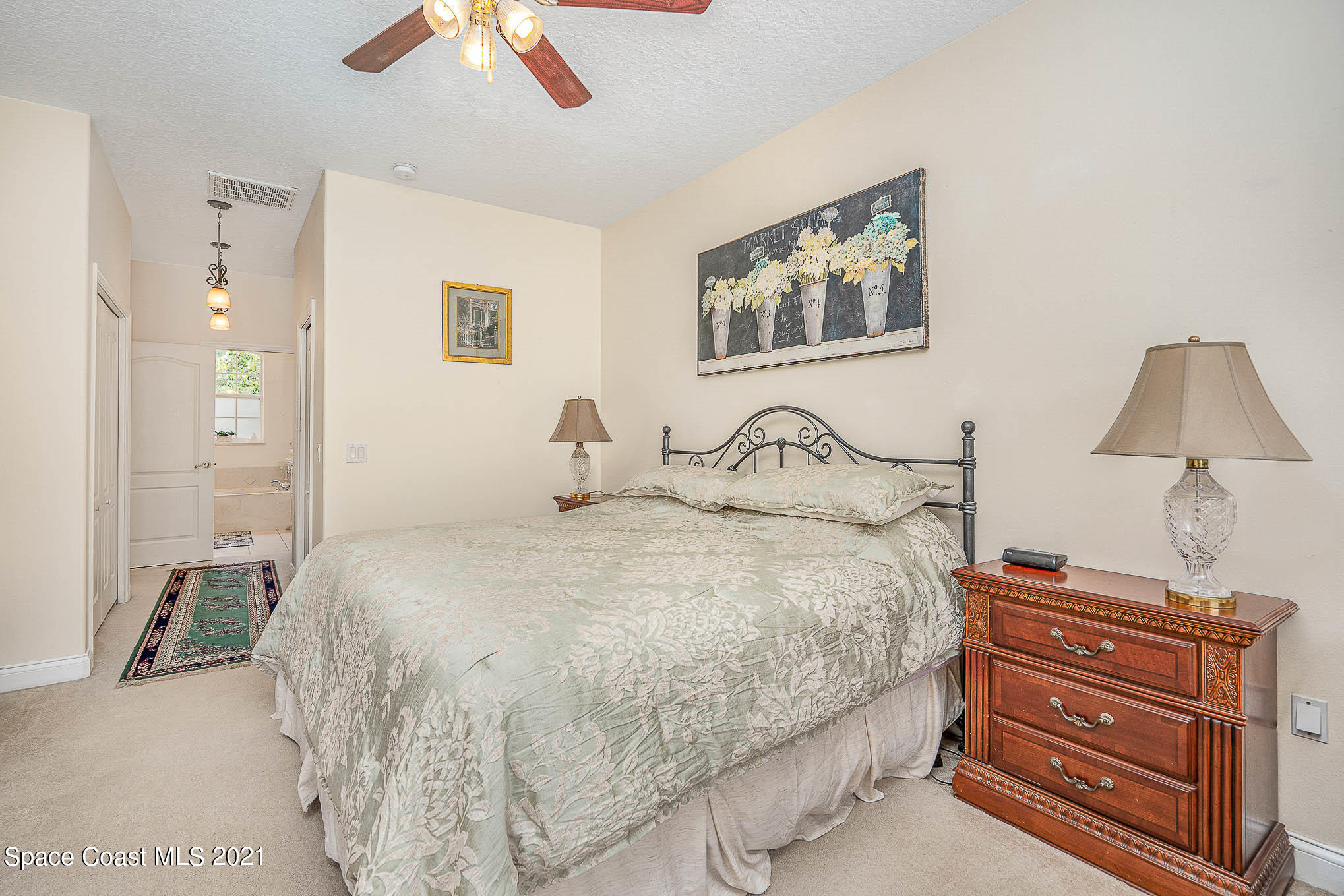 5080 Craig Road Cocoa, FL 32926 - Photo 15 of 41 a bedroom with a bed and a chandelier