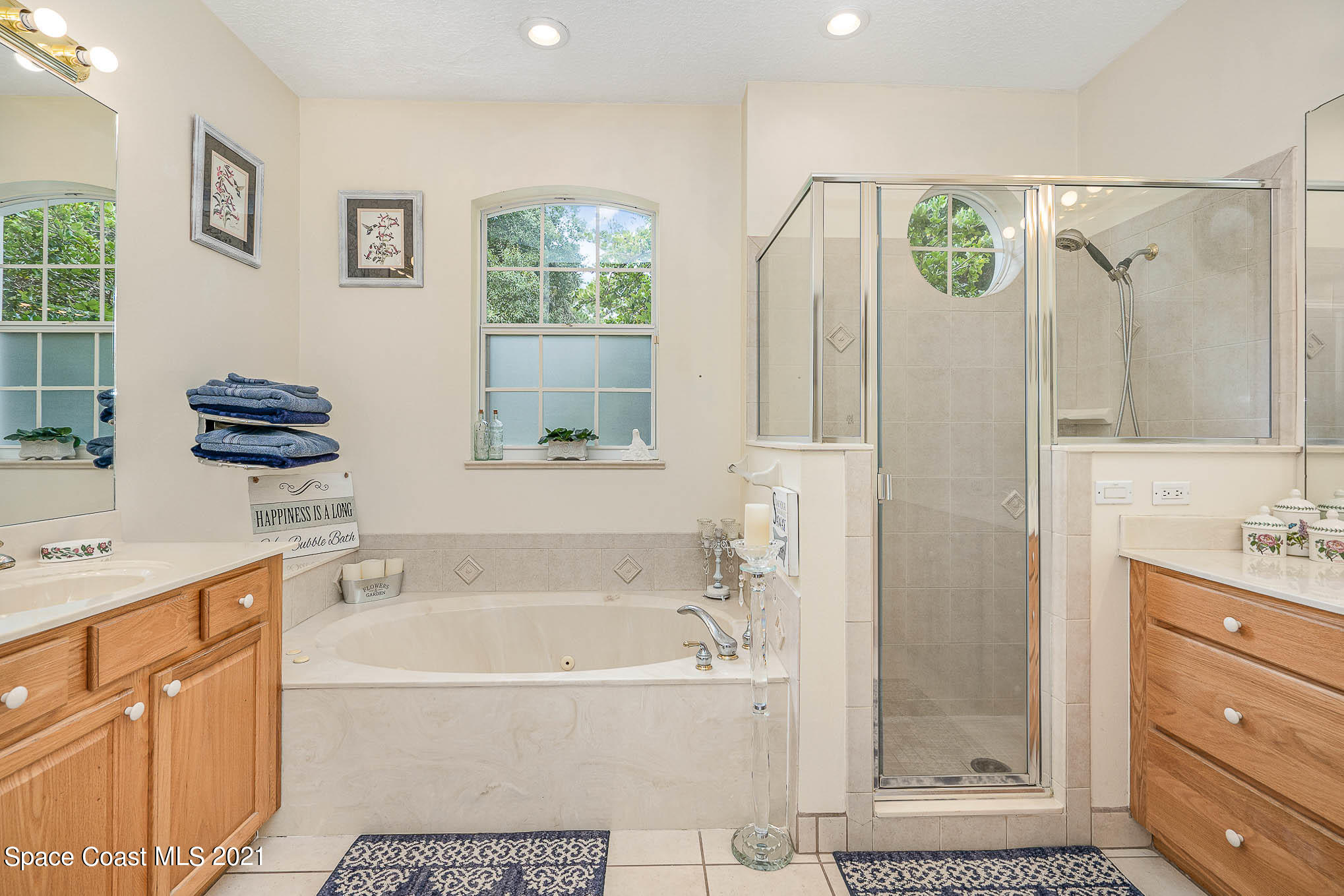 5080 Craig Road Cocoa, FL 32926 - Photo 16 of 41 a bathroom with a tub a sink and a shower