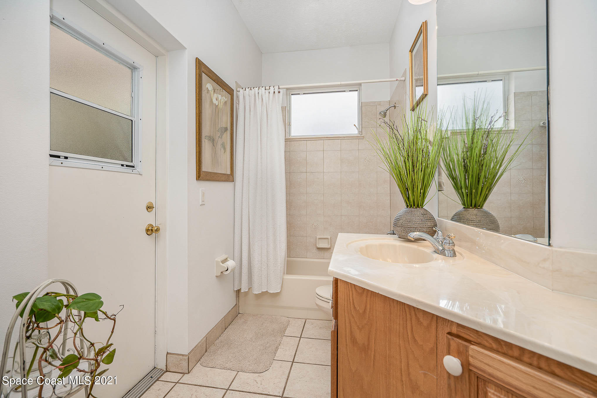 5080 Craig Road Cocoa, FL 32926 - Photo 18 of 41 a bathroom with a granite countertop sink a potted plant and a mirror