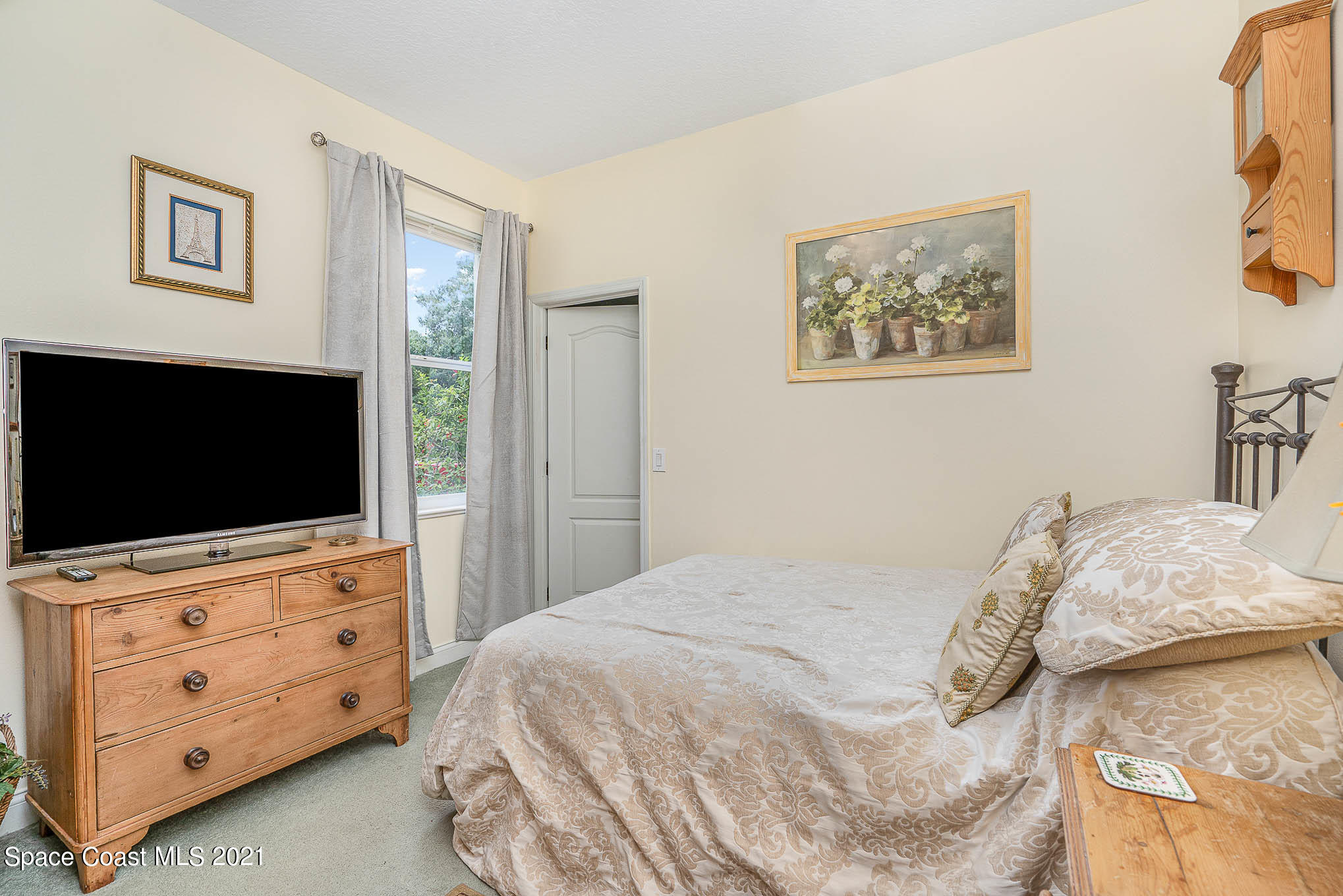 5080 Craig Road Cocoa, FL 32926 - Photo 19 of 41 a bedroom with a bed and a flat screen tv