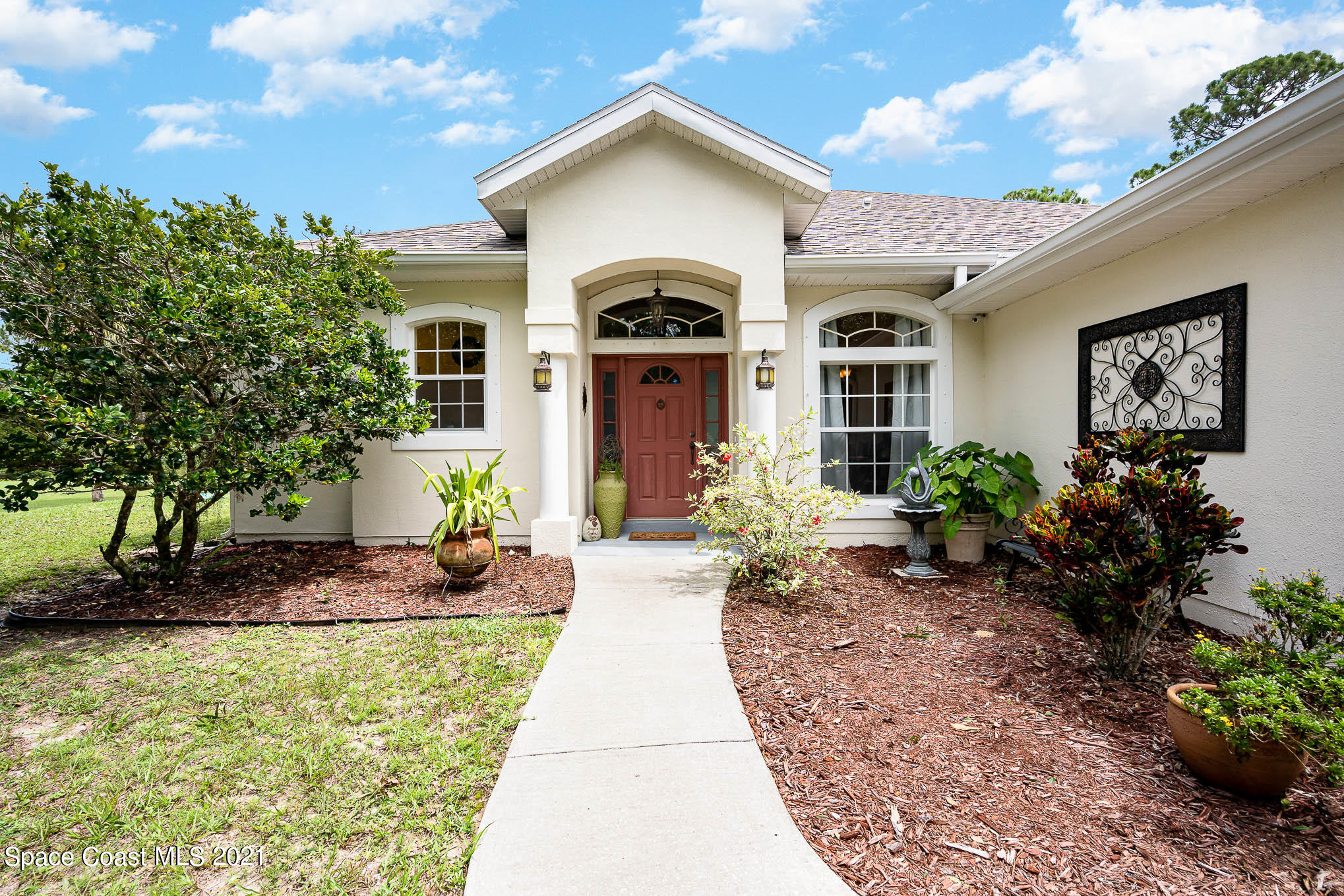 5080 Craig Road Cocoa, FL 32926 - Photo 3 of 41 a front view of a house with garden
