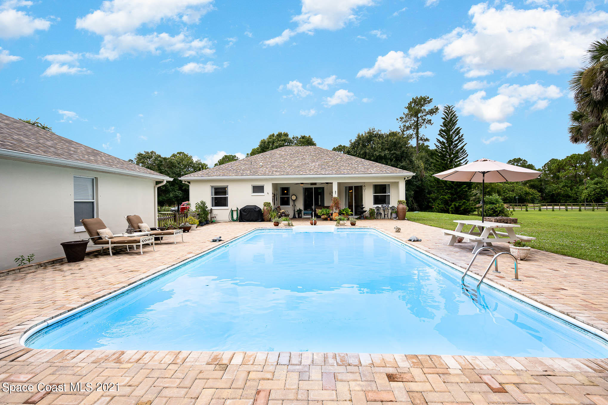 5080 Craig Road Cocoa, FL 32926 - Photo 22 of 41 a view of a house with swimming pool and sitting area