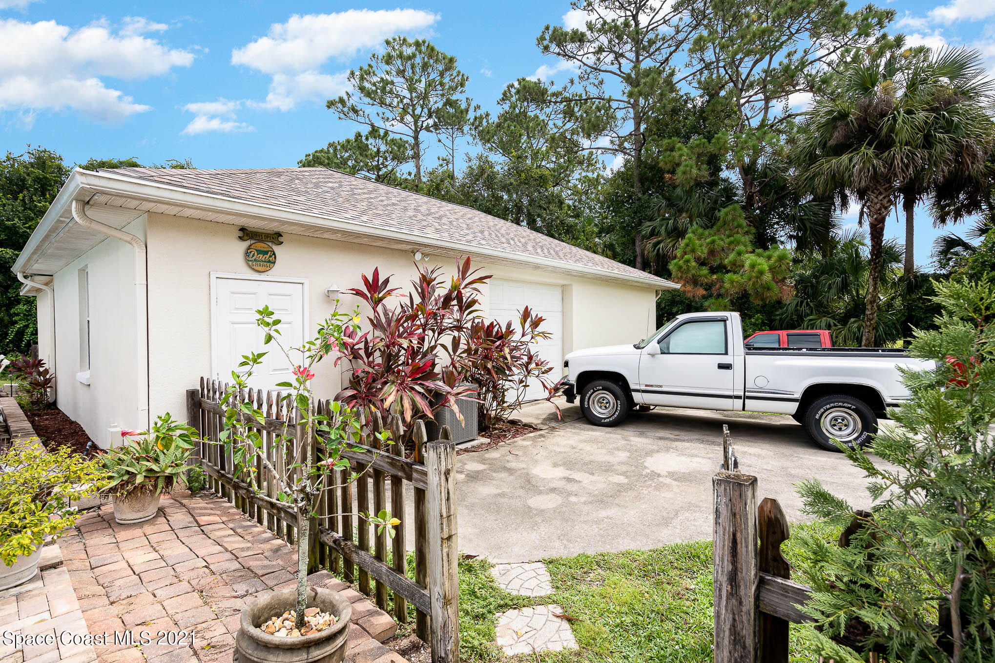5080 Craig Road Cocoa, FL 32926 - Photo 25 of 41 a view of a house with a garden and parking space