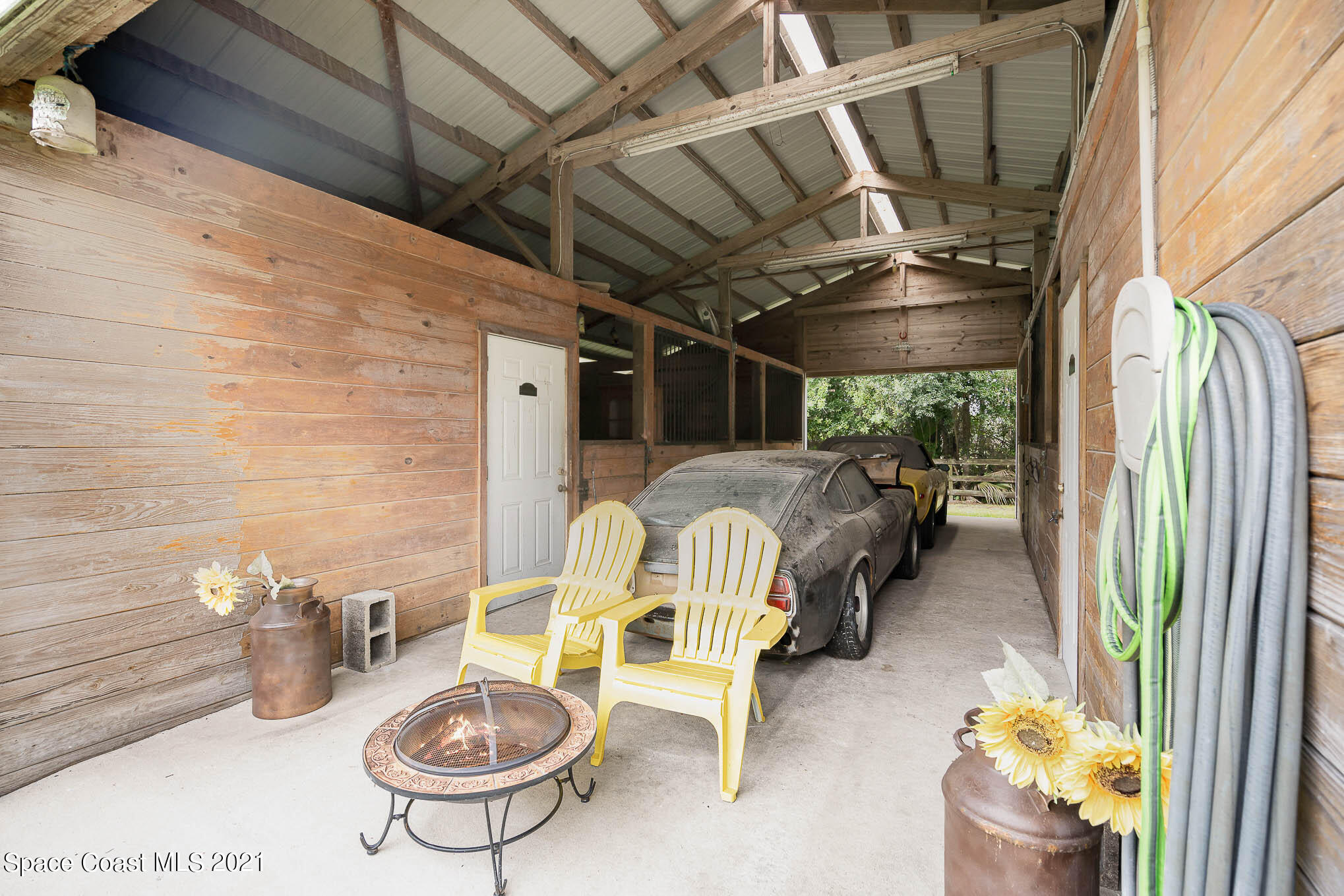 5080 Craig Road Cocoa, FL 32926 - Photo 31 of 41 a view of a patio with table and chairs potted plants