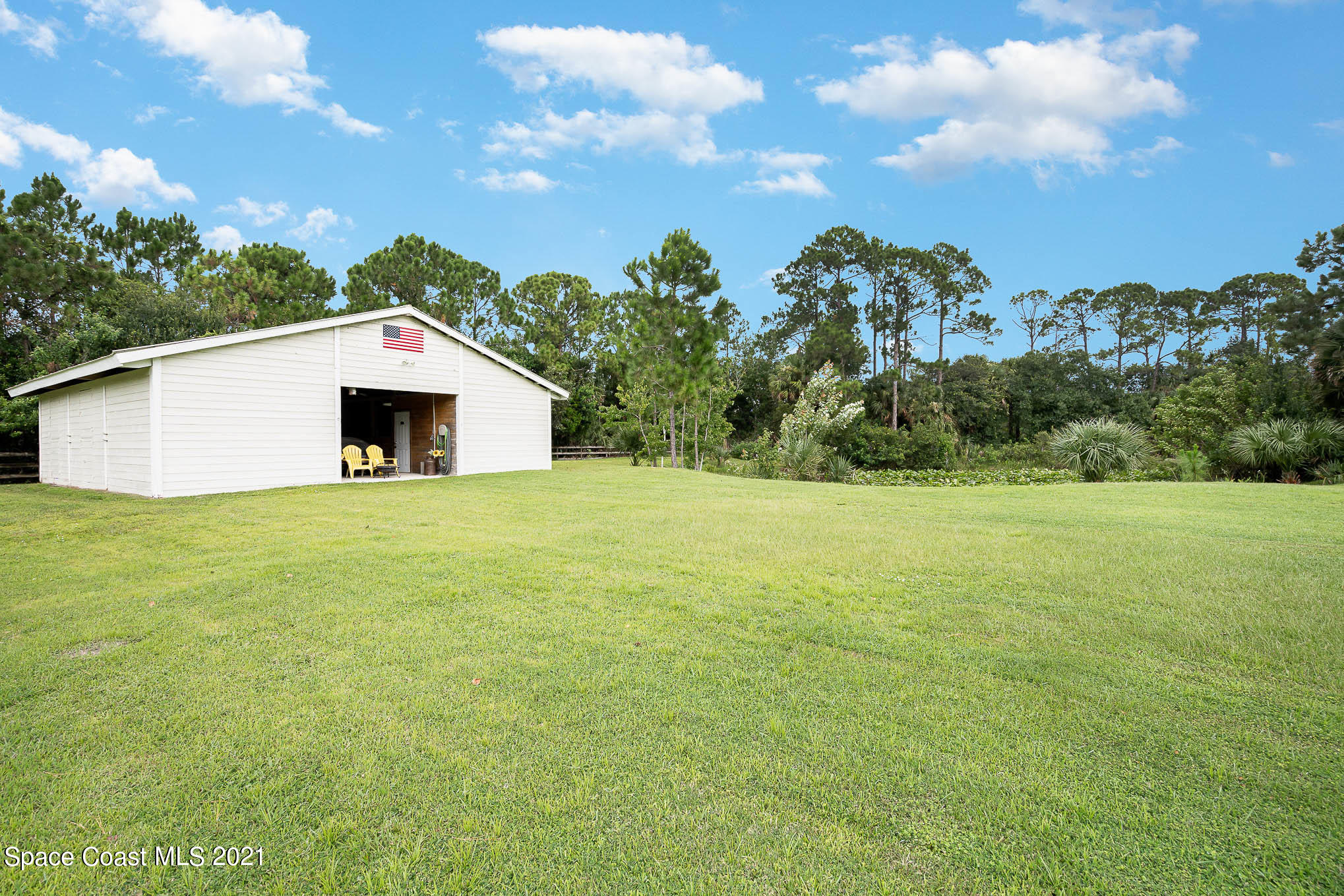 5080 Craig Road Cocoa, FL 32926 - Photo 32 of 41 a white house with a big yard and large tree