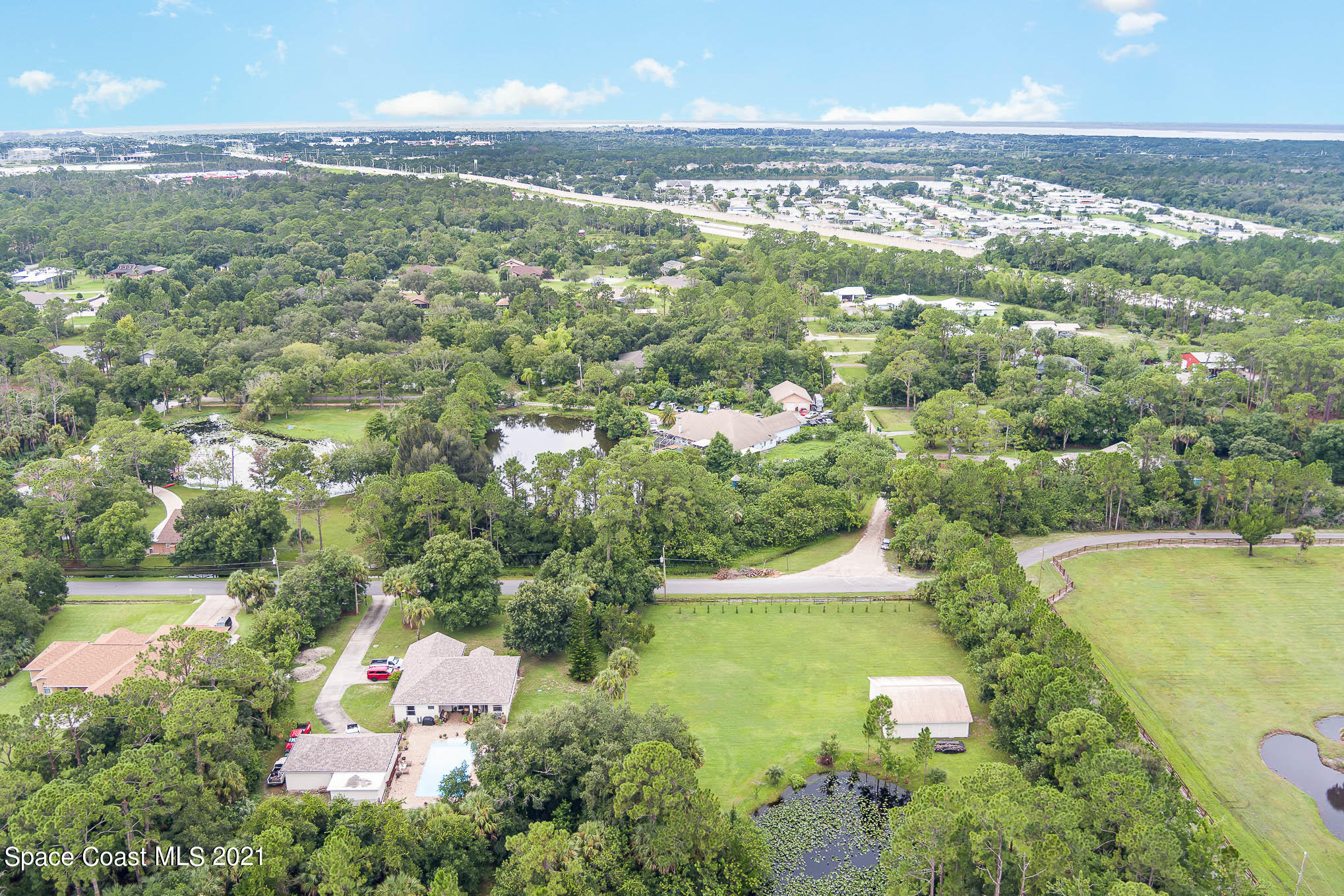 5080 Craig Road Cocoa, FL 32926 - Photo 40 of 41 an aerial view of a house with a garden and lake view