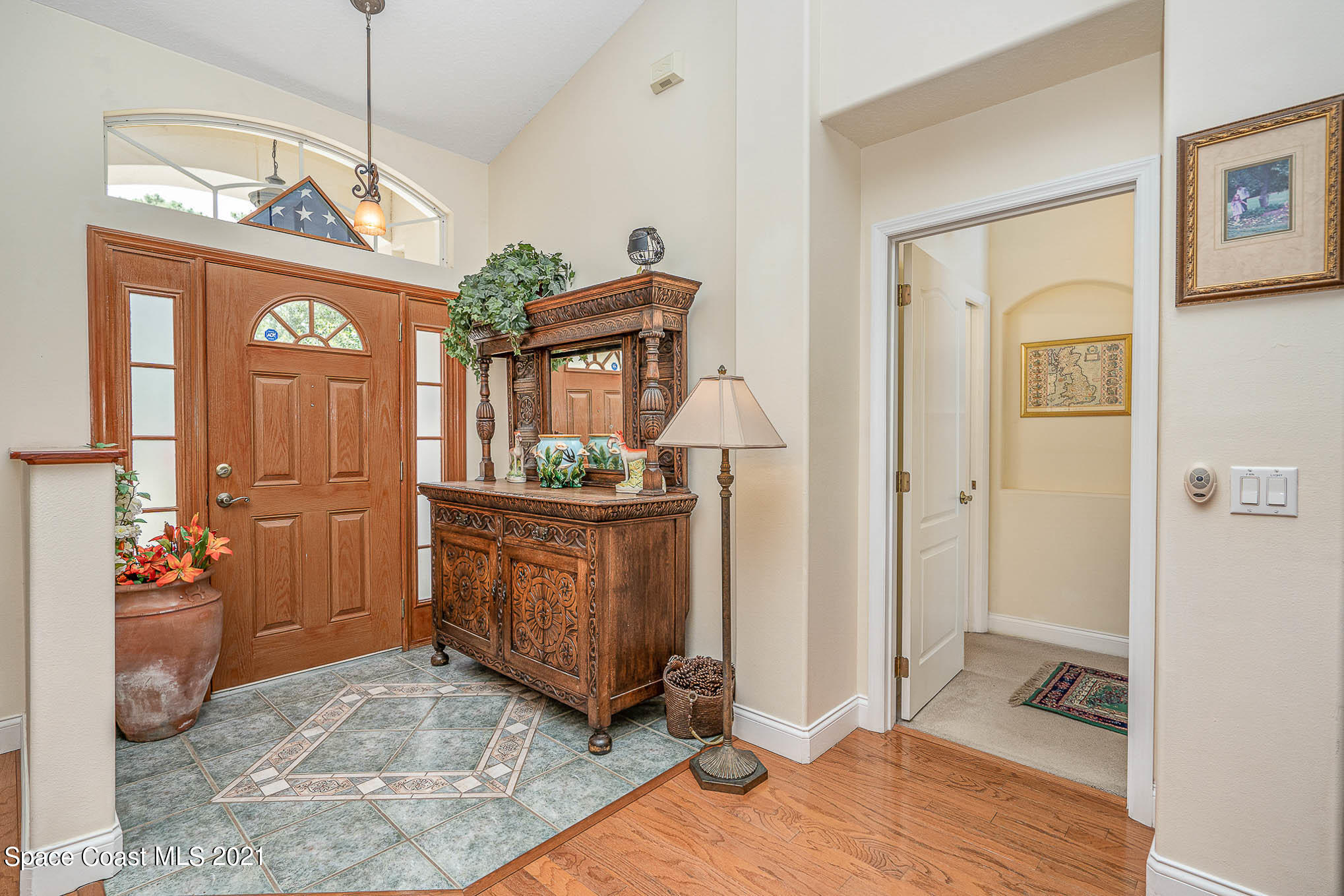 5080 Craig Road Cocoa, FL 32926 - Photo 8 of 41 a view of a hallway with wooden floor and a living room