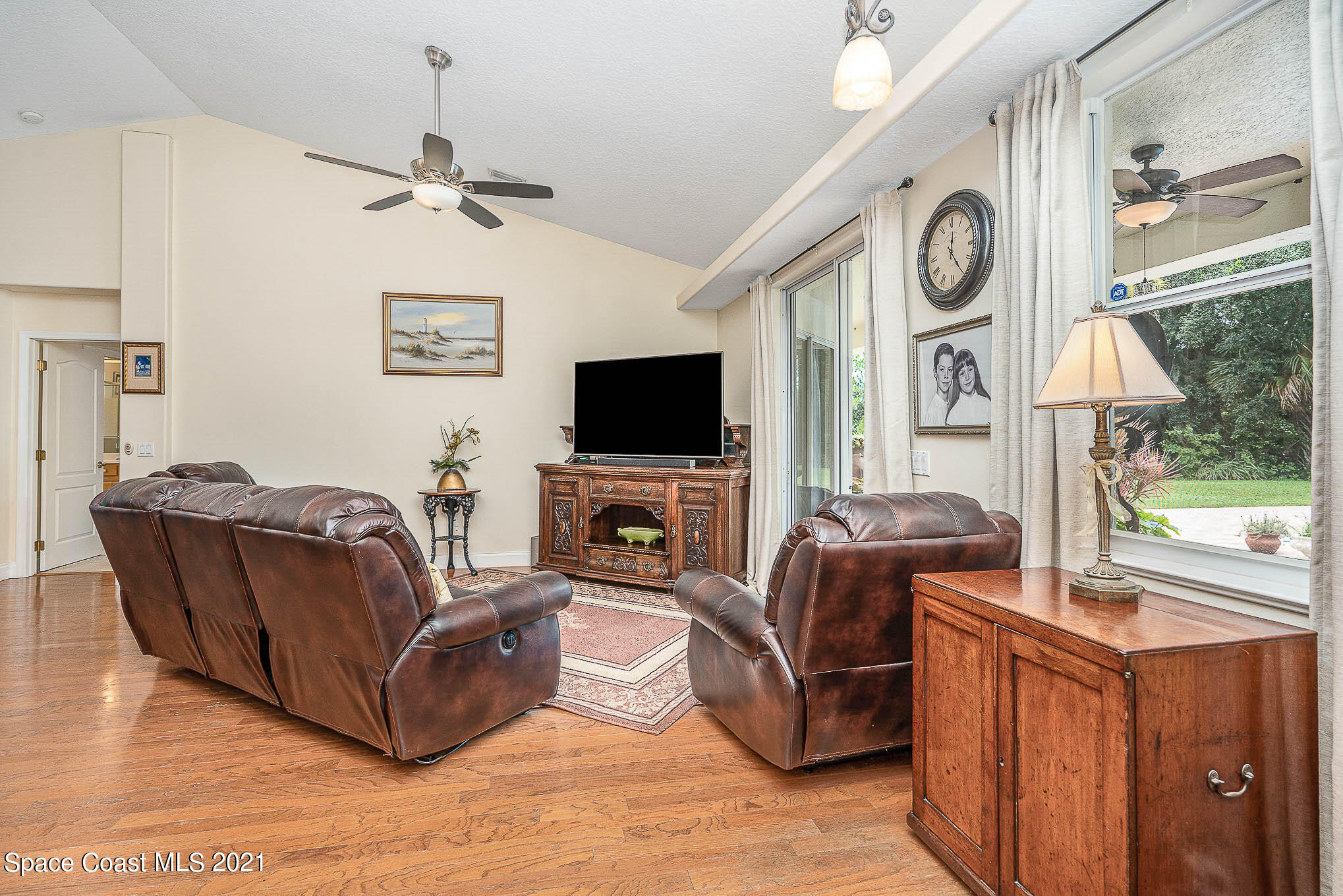 5080 Craig Road Cocoa, FL 32926 - Photo 9 of 41 a living room with furniture a flat screen tv and a window
