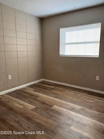 a kitchen with a refrigerator and a stove top oven