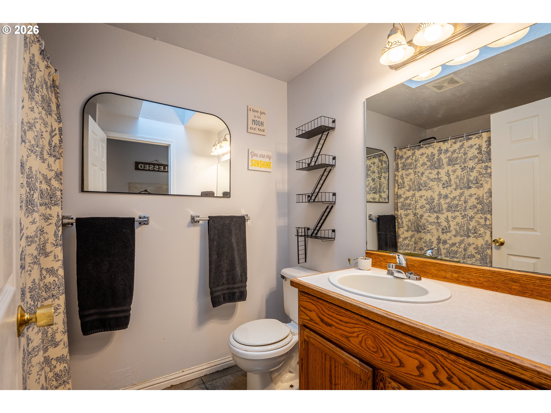 90 South 17th Street Cottage Grove, OR 97424 - Photo 15 of 23 a bathroom with a sink a toilet and mirror