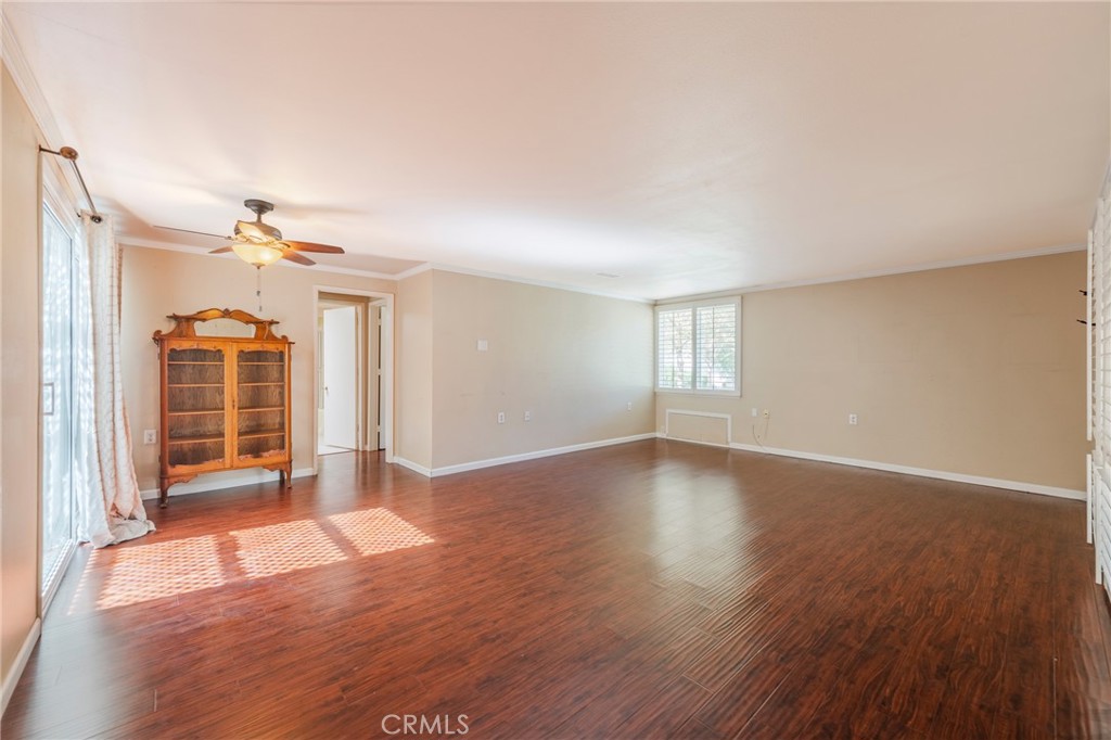 43 Calle Aragon, Unit C Laguna Woods, CA 92637 - Photo 13 of 41 an empty room with wooden floor and windows