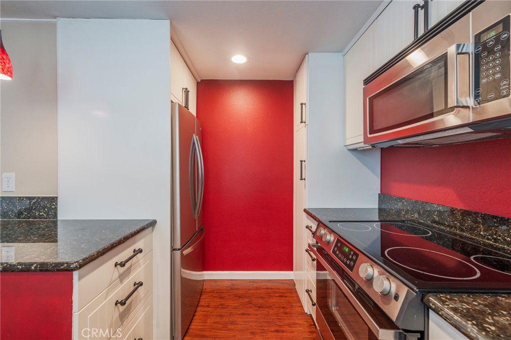 43 Calle Aragon, Unit C Laguna Woods, CA 92637 - Photo 15 of 41 a kitchen with granite countertop a stove and a sink