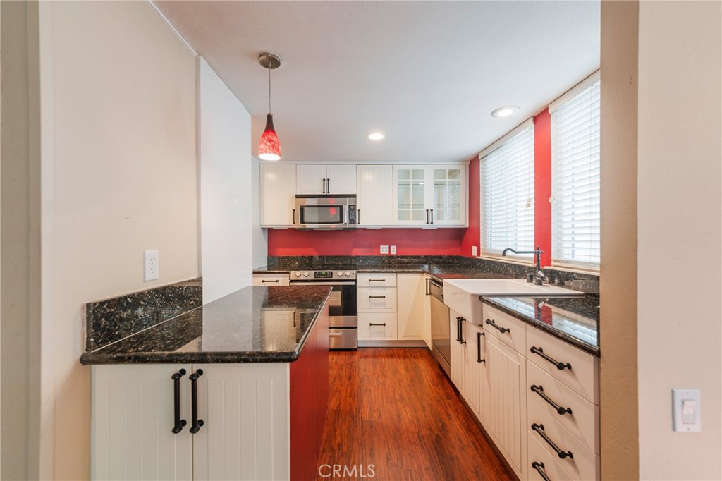 43 Calle Aragon, Unit C Laguna Woods, CA 92637 - Photo 16 of 41 a kitchen with stainless steel appliances granite countertop a stove and a refrigerator