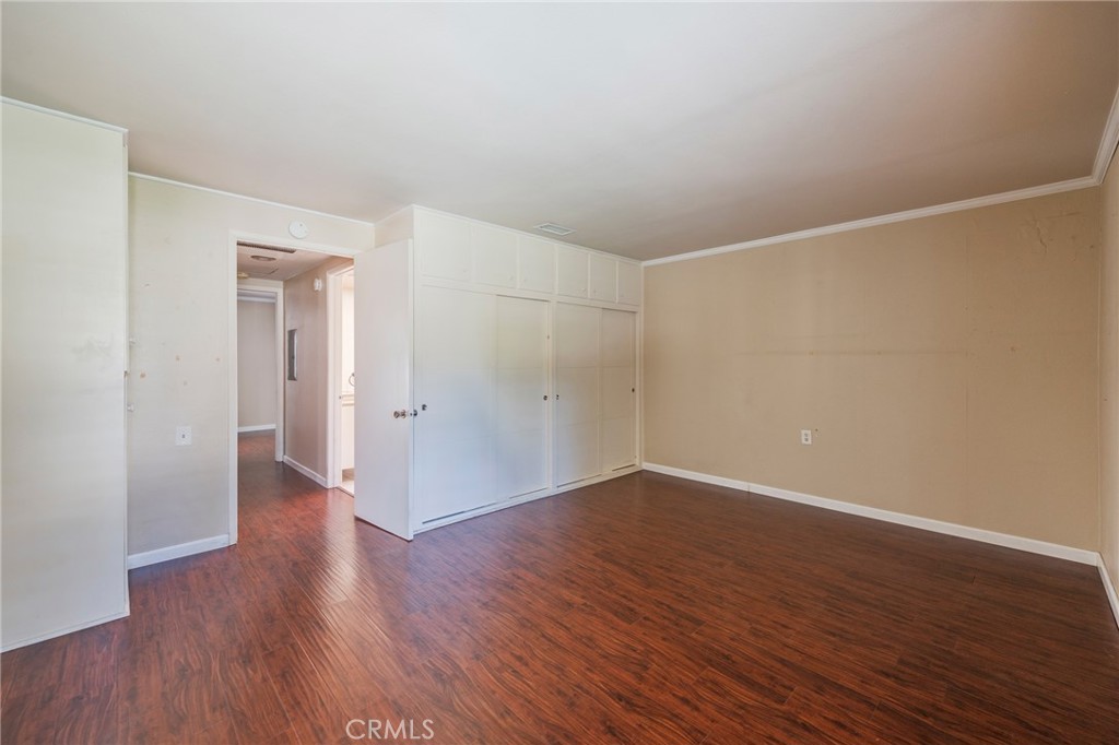 43 Calle Aragon, Unit C Laguna Woods, CA 92637 - Photo 21 of 41 a view of an empty room with wooden floor