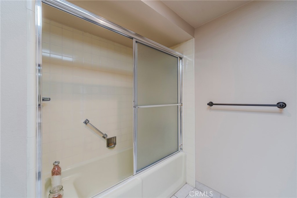 43 Calle Aragon, Unit C Laguna Woods, CA 92637 - Photo 23 of 41 a bathroom with a glass shower door