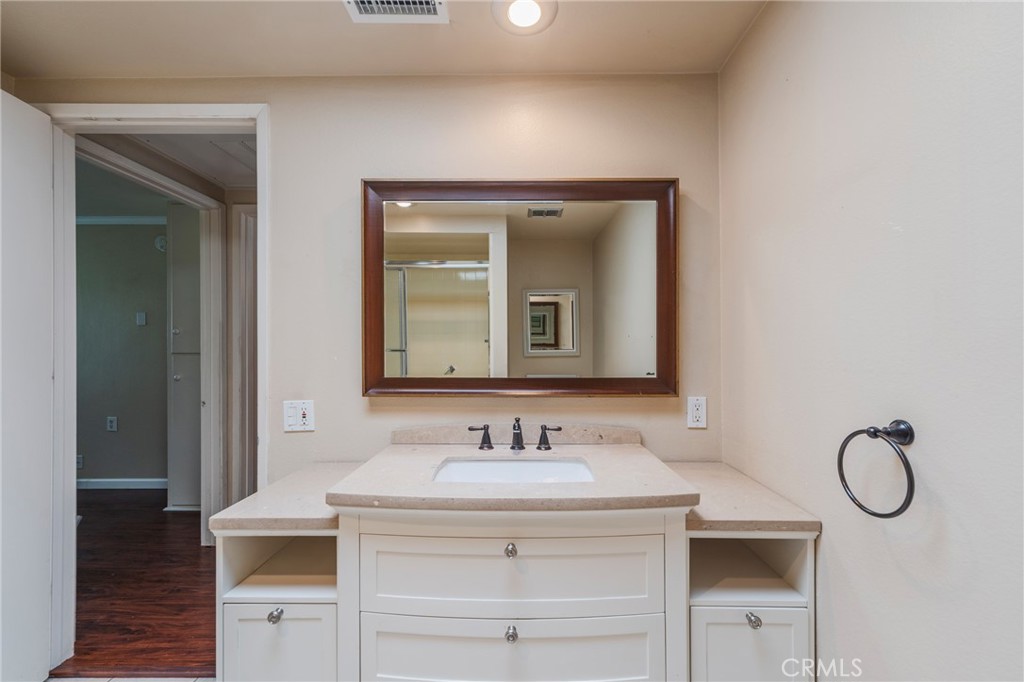 43 Calle Aragon, Unit C Laguna Woods, CA 92637 - Photo 25 of 41 a bathroom with a granite countertop sink and a mirror