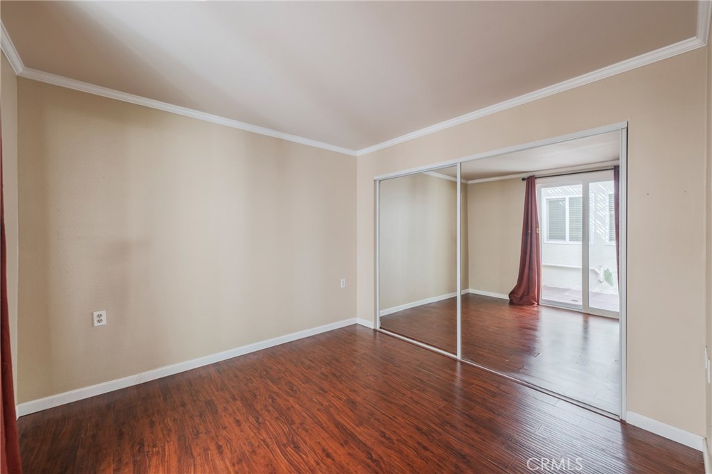 43 Calle Aragon, Unit C Laguna Woods, CA 92637 - Photo 9 of 41 a view of an empty room with wooden floor and a window