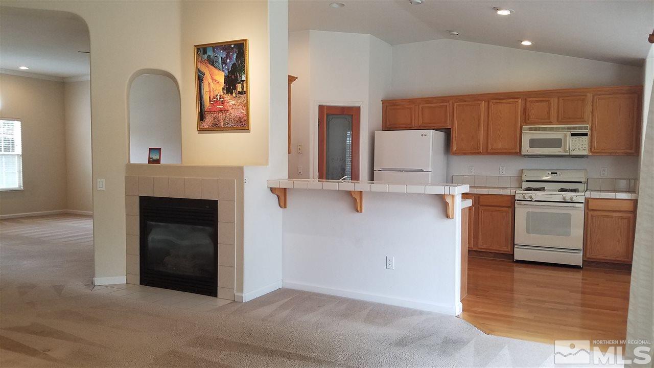 706 Putnam Court Reno, NV 89503 - Photo 8 of 20 a kitchen with stainless steel appliances granite countertop a stove and a refrigerator