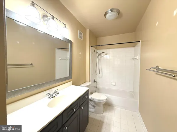 a bathroom with a double vanity sink toilet mirror and shower