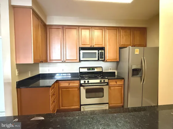 a kitchen with a stove microwave and refrigerator