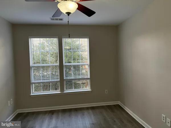a view of wooden floor and windows in a room