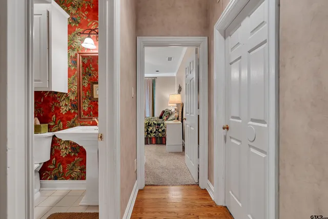 a view of a hallway with wooden floor and closet