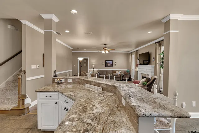 a large kitchen with sink stove and a refrigerator