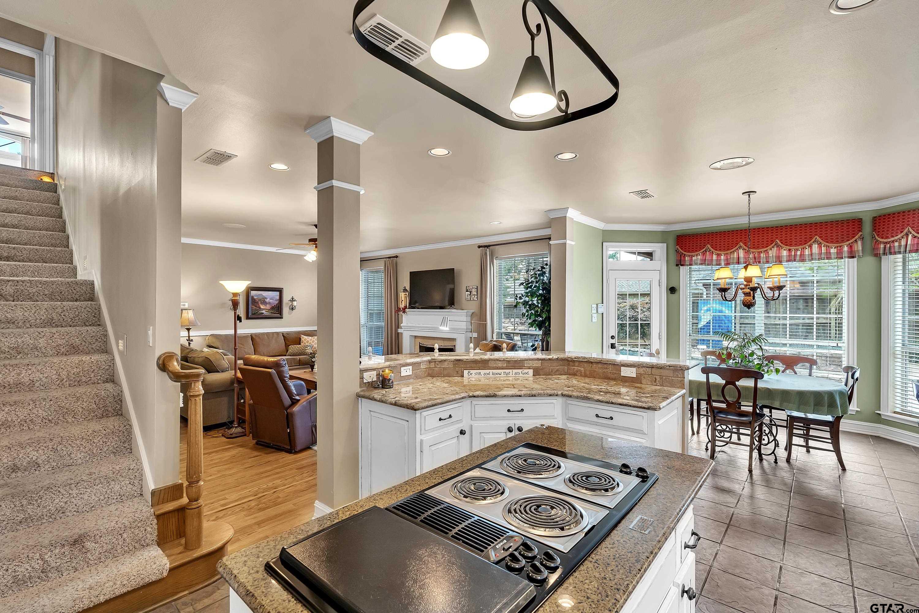 1014 Lovers Lane Longview, TX 75604 - Photo 18 of 45 a kitchen with stainless steel appliances granite countertop a stove and a view of dining hall with wooden floor