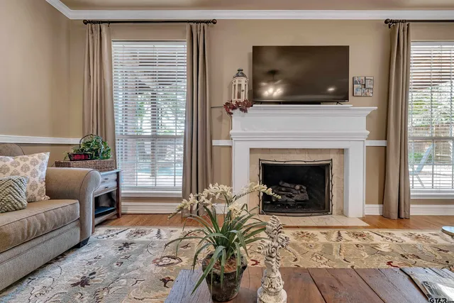 a living room with furniture a flat screen tv and a fireplace