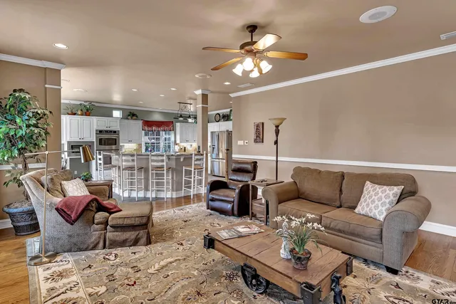 a living room with furniture and a chandelier