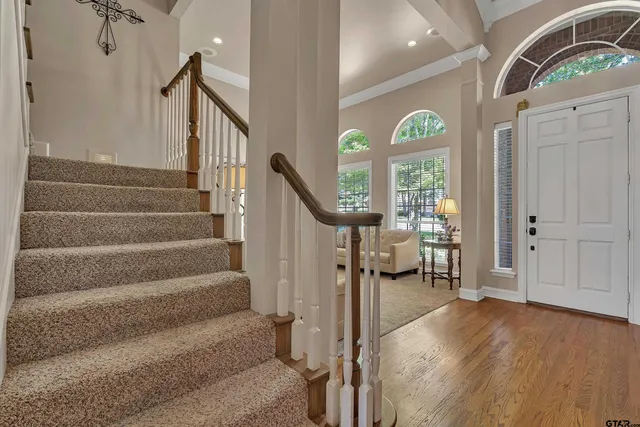 a view of an entryway with wooden floor and a livingroom view
