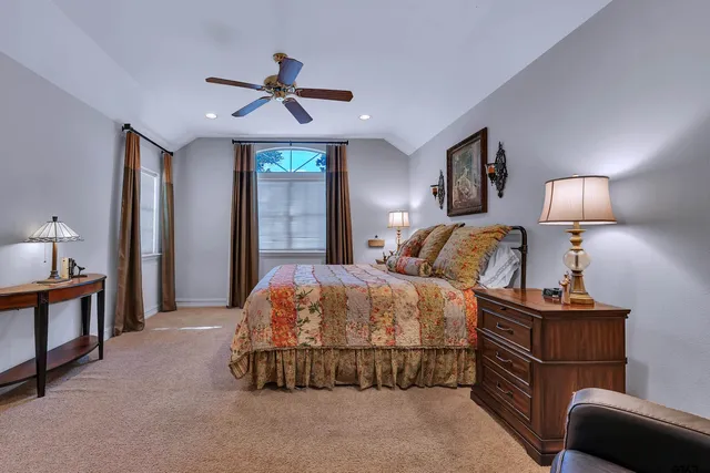 a bedroom with a bed and a lamp with the dresser