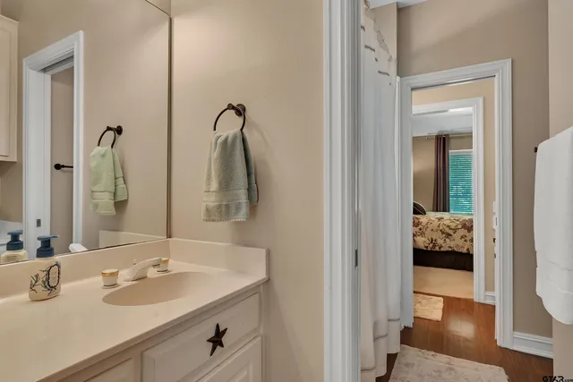 a en suite bathroom with a sink and mirror