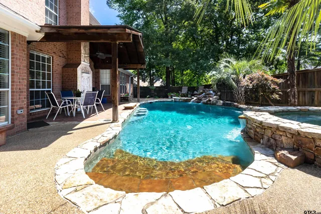 a view of a house with a yard patio and fire pit