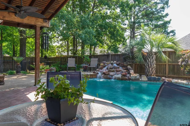 a view of a house with backyard and sitting area