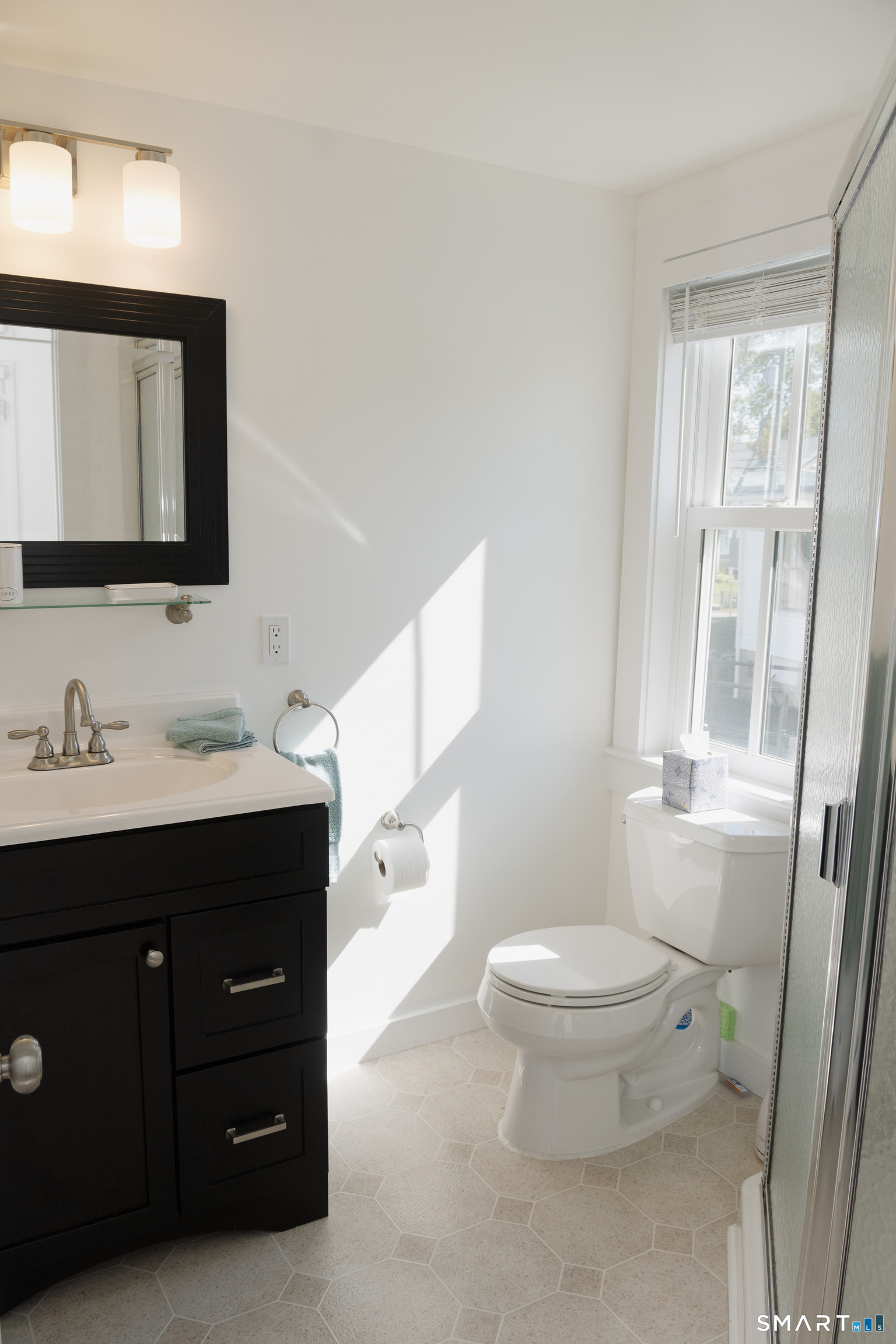 19 Pearl Street Groton, CT 06355 - Photo 23 of 39 a bathroom with a toilet sink and mirror