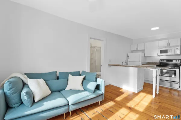 a living room with furniture and kitchen view