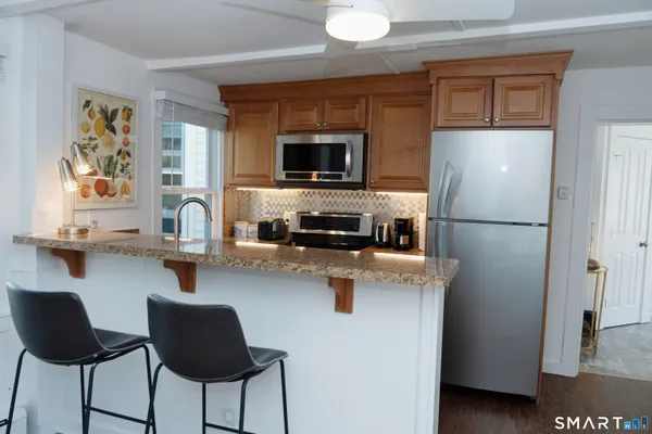 a kitchen with a refrigerator and a stove top oven