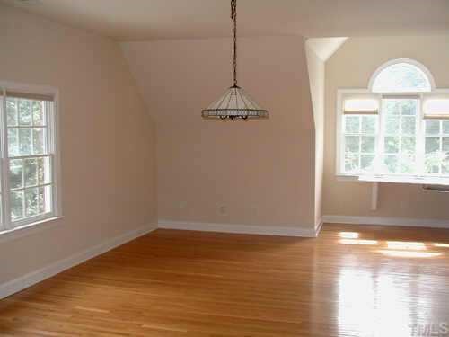 5212 Azure Lane Raleigh, NC 27613 - Photo 8 of 10 a view of a room with wooden floor chandelier and windows